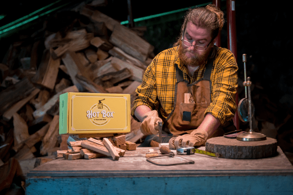A man crafts Hot Box 6" pizza oven wood