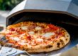 Removing homemade pizza from a portable pizza oven