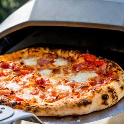 Removing homemade pizza from a portable pizza oven