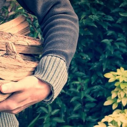 Man collecting firewood for delivery